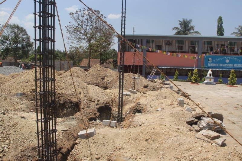 Baubeginn Sambhota Schule Bylakuppe Stahlstützen in Baugrube